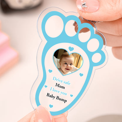 Long view of drive safe baby footprint charm with dimensions 3.35 x 2.36 inches.