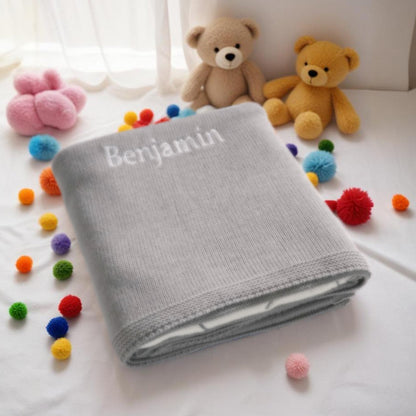 Machine-washable baby blanket on gentle cycle with grey elephant design.