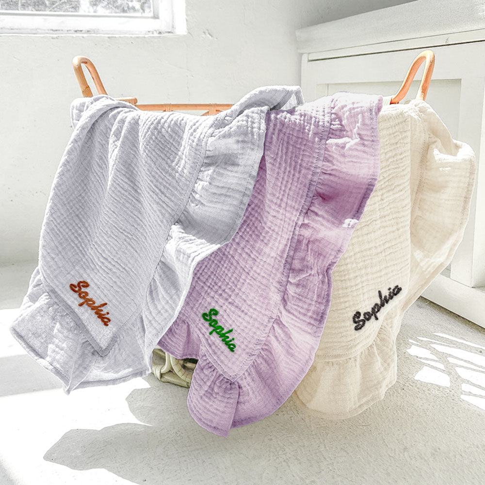 Soft cotton muslin swaddle blanket draped to show generous 120cm square size