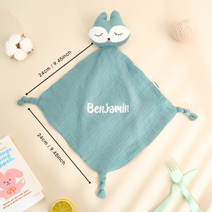 Baby holding a personalised embroidered comfort towel — soft cotton soother with name stitching, a treasured newborn keepsake