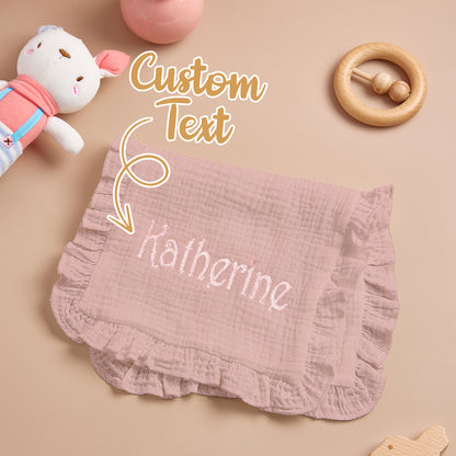 Embroidered name visible against white muslin backdrop.