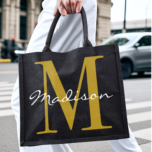 Main product shot of personalised black canvas tote with custom name and initial on the front — stylish, durable gift for birthdays, weddings and everyday use