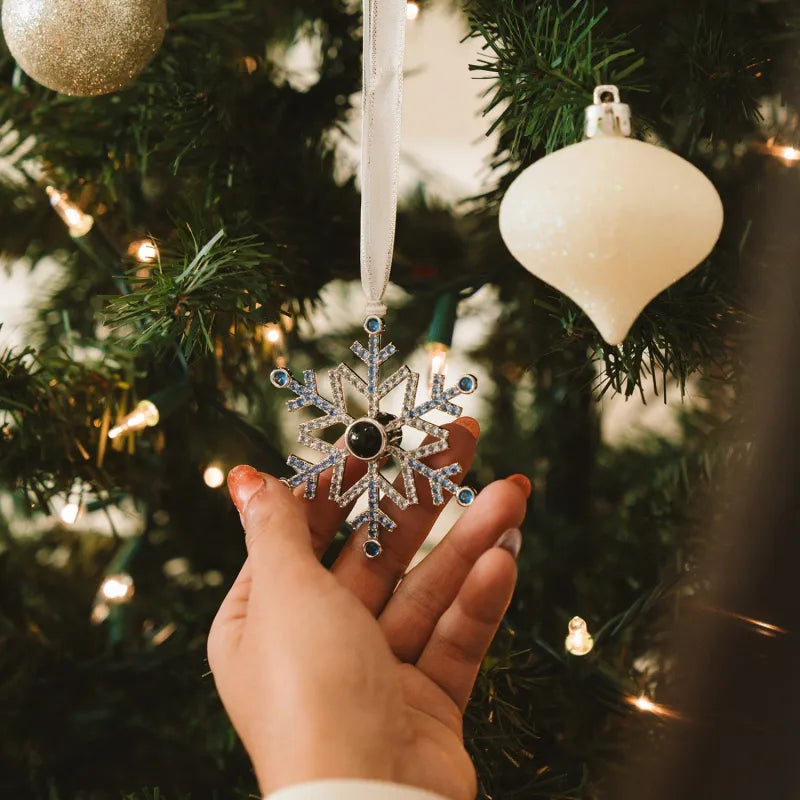 Personalised blue snowflake photo projection ornament hanging on a Christmas tree, handcrafted alloy keepsake (5×6.3 cm) – custom Christmas gift and stocking filler
