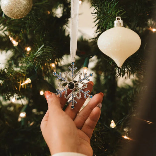 Personalised blue snowflake photo projection ornament hanging on a Christmas tree, handcrafted alloy keepsake (5×6.3 cm) – custom Christmas gift and stocking filler