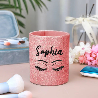 Personalised glitter leather brush cup holding a selection of makeup brushes, illustrating organised vanity storage and easy-to-use design