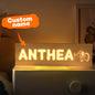 Detail of the warm LED diffuser behind engraved letters on a personalised wooden night light — soft light for toddler bedrooms