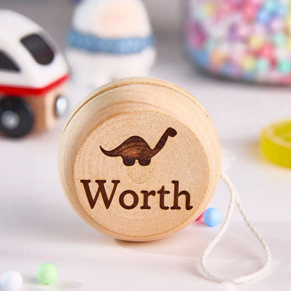 Collection of personalised wooden yo-yos each with different engraved names — ideal name gifts for kids, teens and classmates