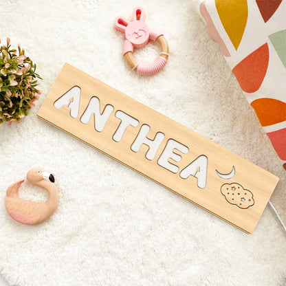 Close-up of the lamp base showing stable wooden stand and cable entry on a personalised wooden night light — safe nursery lamp