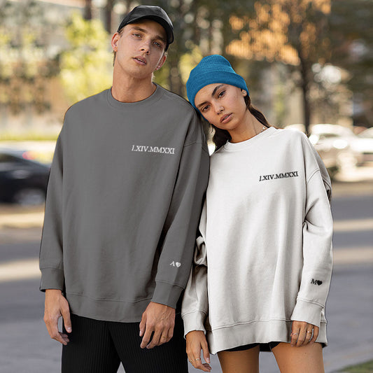 Personalised embroidered couple hoodie front view with Roman numeral date — round-neck unisex gift for anniversaries