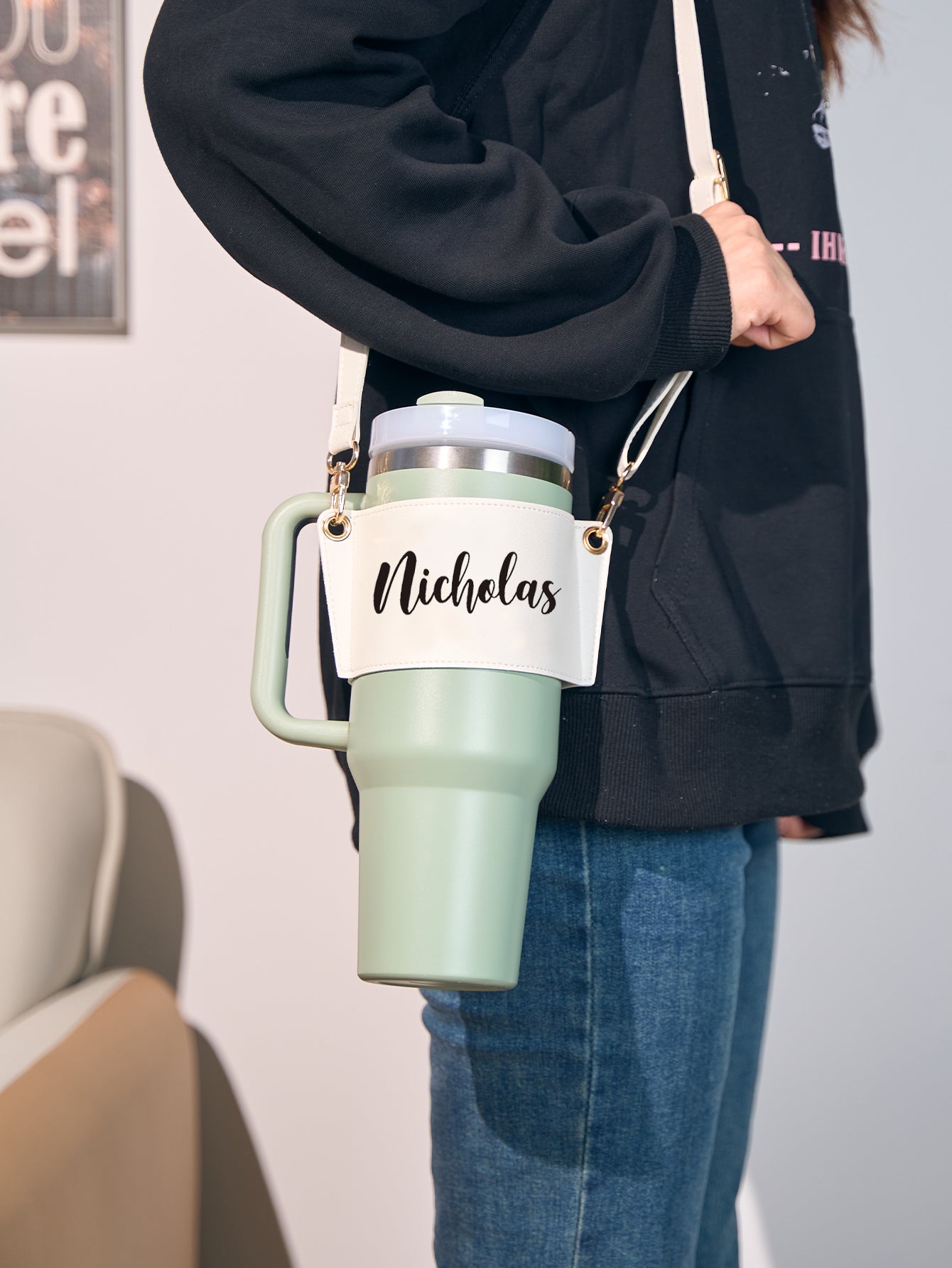 Model wearing personalised 40oz Stanley PU leather carrier bag crossbody to demonstrate adjustable strap length and hands-free convenience — great gift for her