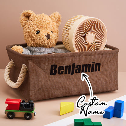 Close-up of the linen texture and printed name on the personalised toy bin; handcrafted look.