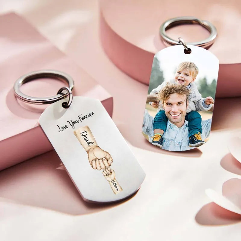 Close-up of engraved-look stainless steel keyring detail with personalised names and family fist design – keepsake for Dad