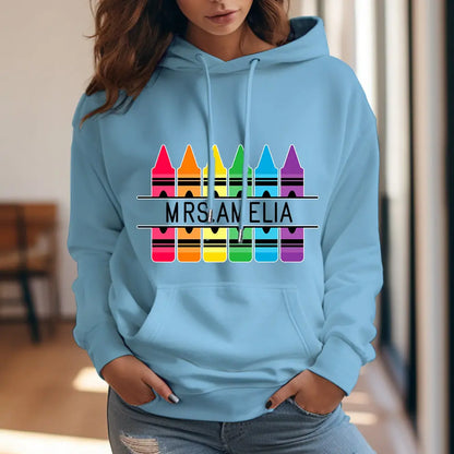 Colour variant of the personalised crayon hooded sweatshirt with printed name — playful crayon graphic for Mother's Day, mentor or classmate gifts