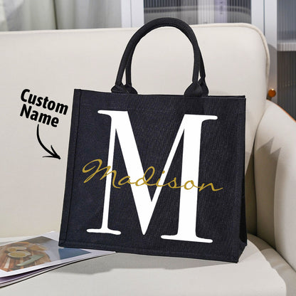 Detail shot of sturdy handles and reinforced stitching on personalised black canvas name and initial tote, highlighting durable construction