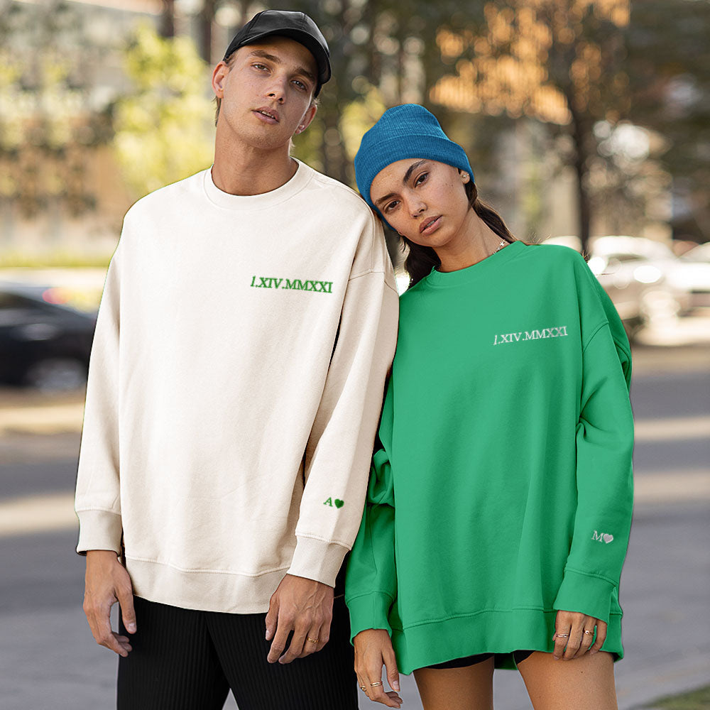 Embroidery machine close-up stitching Roman numerals onto personalised couple hoodies — quality production process