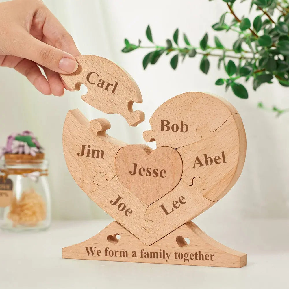 Close-up of engraved name blocks from personalised wooden heart puzzle showing precise laser engraving and interlocking jigsaw construction