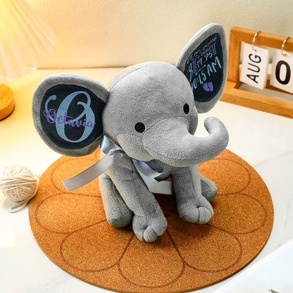 Close-up of the elephant plush head and face, showcasing soft fabric and detailed stitching.