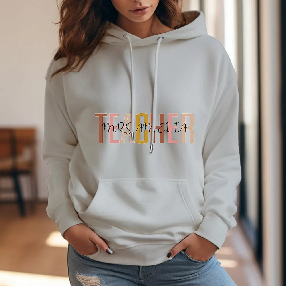Casual lifestyle image of personalised teacher hoodie being worn at school — classic custom name hoodie, perfect as a back-to-school or teacher appreciation gift