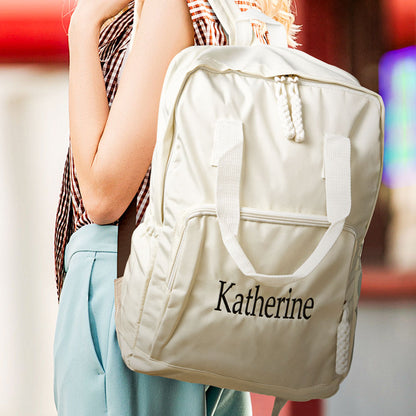 Lifestyle image of person wearing a personalised name embroidered backpack in the city — a practical and stylish custom travel bag gift for friends