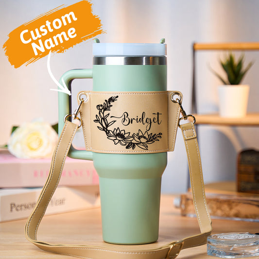 Personalised floral 40oz Stanley tumbler carrier bag in PU leather front view with tumbler inside and adjustable strap