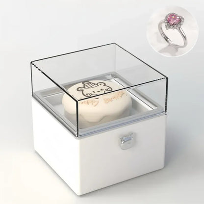 Bear Cake Ring Box displaying an engagement ring on the rising mechanism — ideal for Valentine's Day or promise ring moments