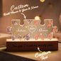 Personalised Couple Puzzle Night Light showing intertwined names and birth flowers laser-etched on gallery-grade acrylic with a sustainable wooden base, warm LED glow — custom name & birth flower LED gift for anniversaries