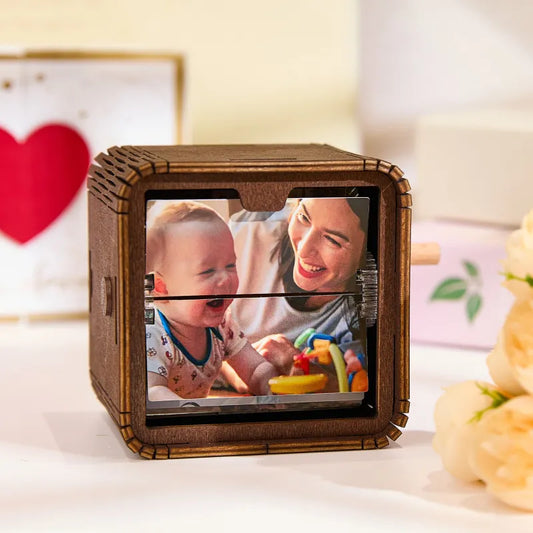 Custom hand-crank flipbook frame displaying 16 personalised photos with LED lighting and built-in music animation