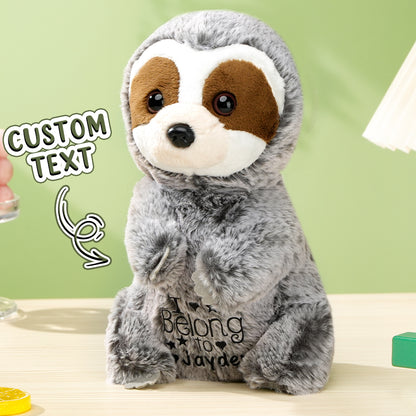 Close up of embroidered name on personalised sloth plush showing neat stitching and soft plush fabric custom baby keepsake