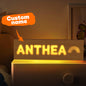 Personalised wooden night light with engraved name lit on a bedside, warm LED custom nursery night light and baby shower gift