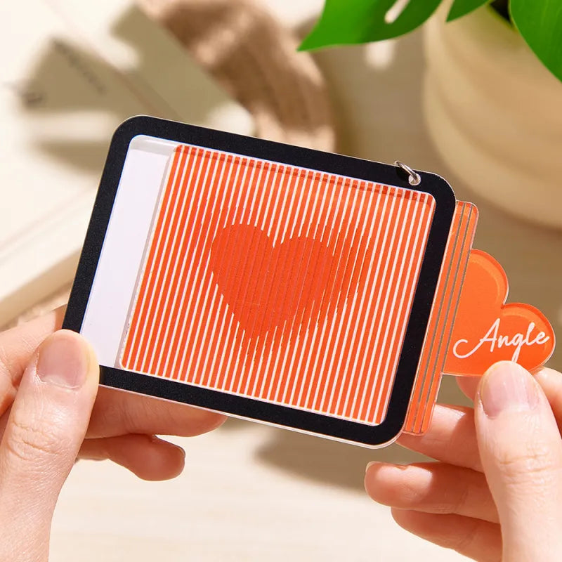 Close-up of personalised engraved outer heart on acrylic pull-out red heart keyring showing custom name engraving and metal ring