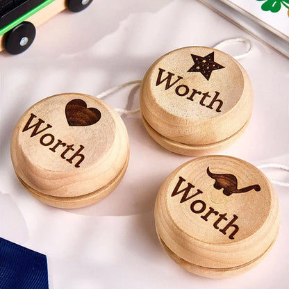 Personalised wooden yo-yo with engraved name on a white background — classic educational birthday gift for kids