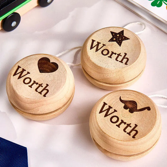 Personalised wooden yo-yo with engraved name on a white background — classic educational birthday gift for kids