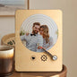 Close-up of engraved wooden music player displaying personalised names and date — bespoke engraved wooden record player