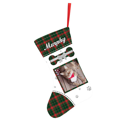 Personalised velvet pet stocking hanging on a mantelpiece, displaying a clear pet photo print and bespoke name in festive colours