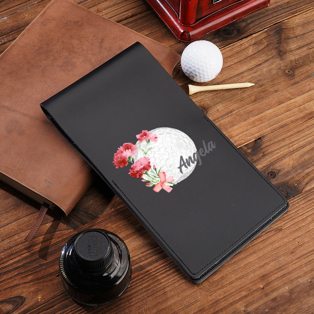 Close-up of birth flower motif and customised name on PU leather golf scorecard holder — elegant personalised golf gift
