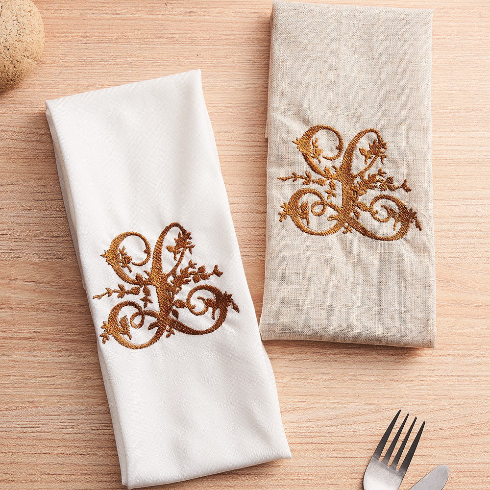 Close-up of high-resolution embroidered monogram on premium linen napkin showing crisp stitching and fine fabric texture — personalised name gift