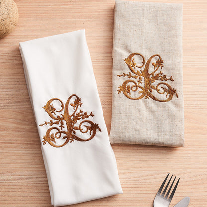 Close-up of high-resolution embroidered monogram on premium linen napkin showing crisp stitching and fine fabric texture — personalised name gift
