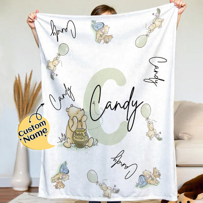 Top-down view of soft flannel Winnie the Pooh blanket with customised name.