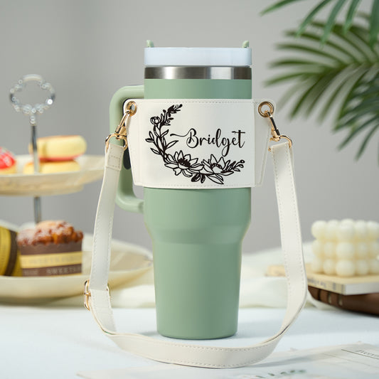 Personalised floral 40oz Stanley tumbler carrier bag in PU leather front view with tumbler inside and adjustable strap