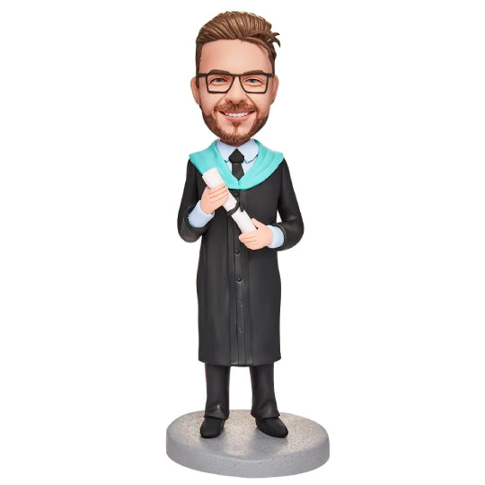 Personalised graduation boy bobblehead holding an engraved certificate, polymer clay figure with customised hair and smiling expression, ideal keepsake