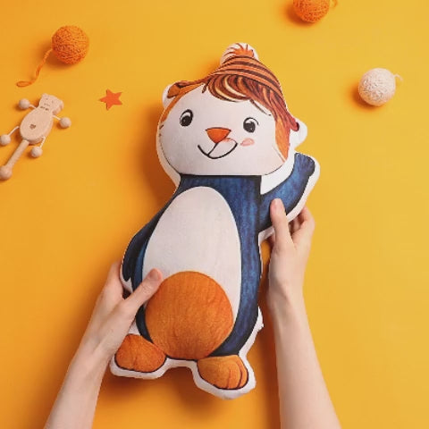 Size comparison of personalised child's drawing plush beside an adult hand to show huggable dimensions and soft cloth