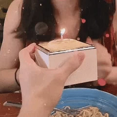Open Bear Cake Ring Box showing the ring elevated on a rotating platform with warm candlelight — ideal for proposals